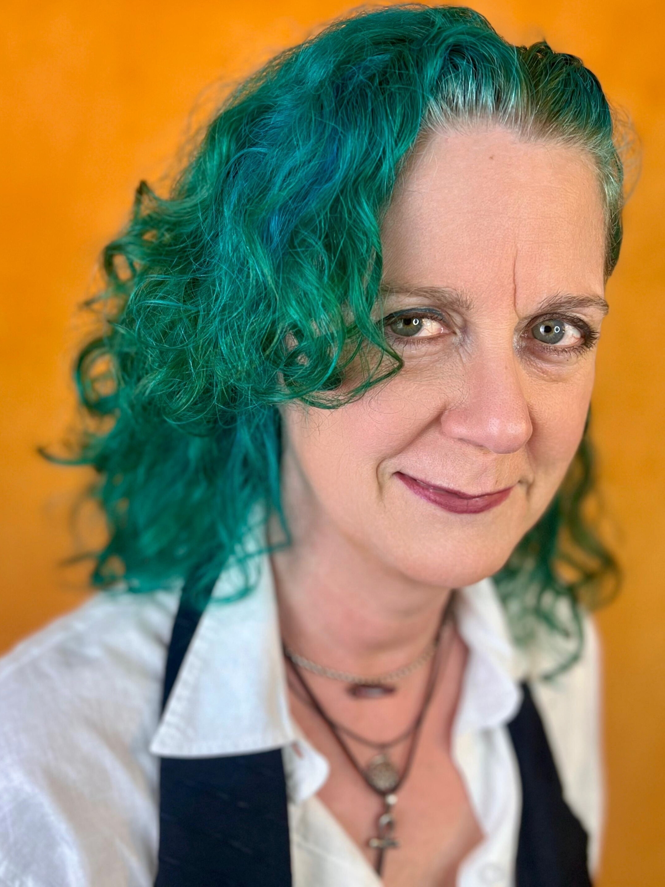 Headshot of Flirty Gwen, grinning from the side