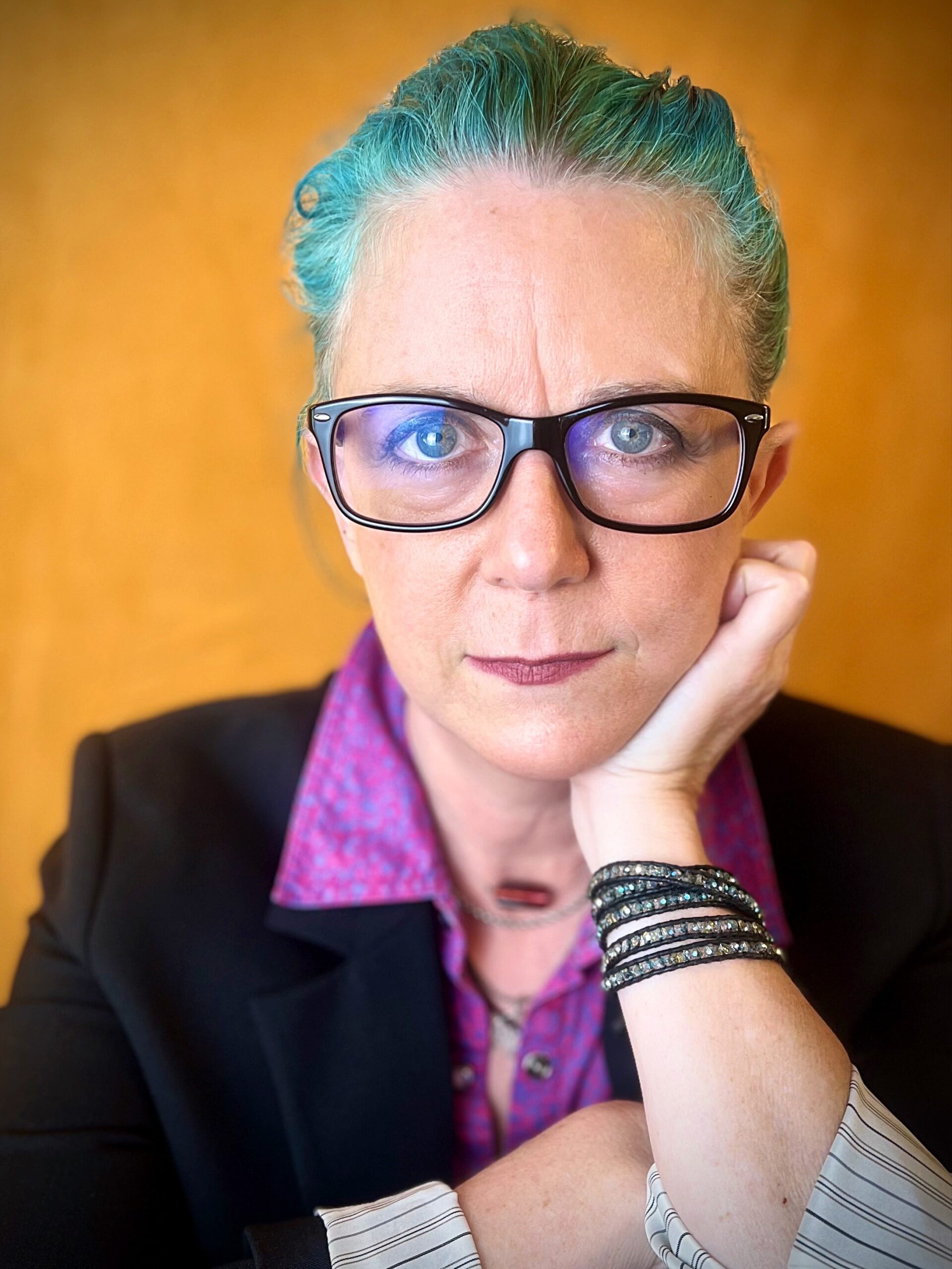 Headshot of Business Gwen, serious with glasses